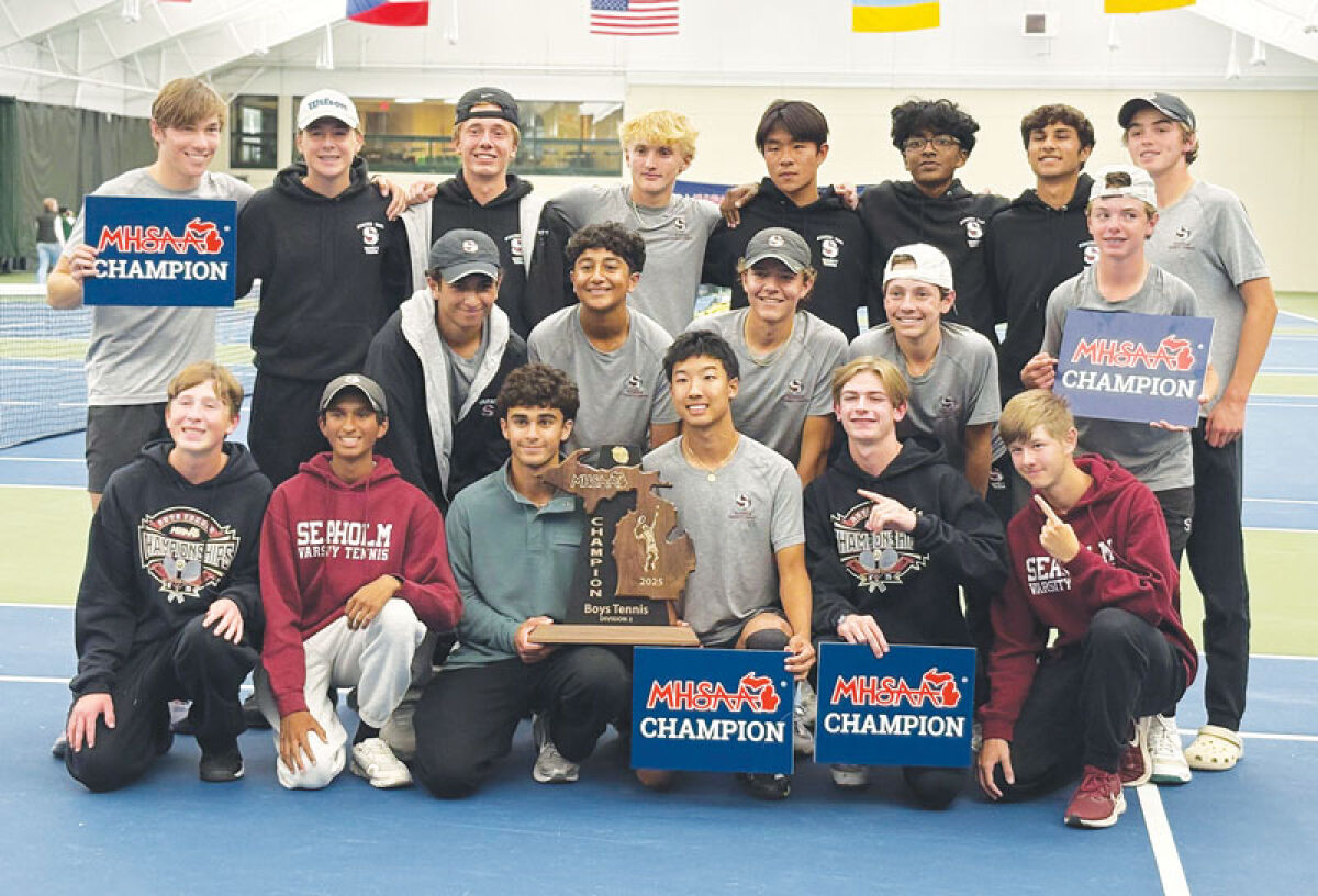  The 2025 Seaholm boys tennis team poses with the Division 2 MHSAA state championship trophy. It’s the team’s first state title. 