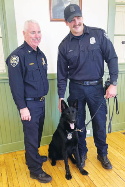  Grosse Pointe Woods Public Safety Director John Kosanke and officer Duncan Gill pose with Arcos, the department’s new K-9, at the Cook Schoolhouse Nov. 17. 