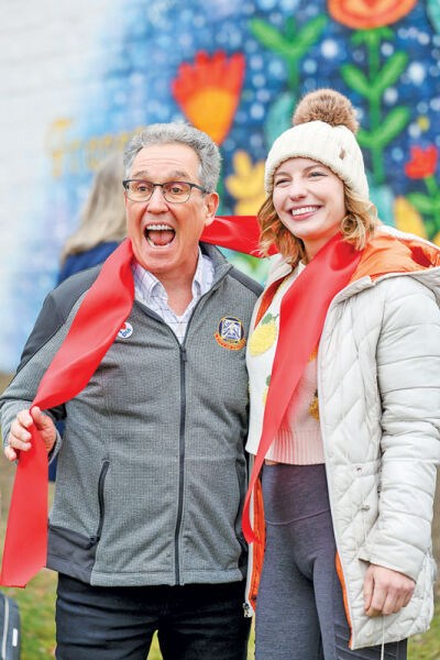  Fraser Mayor Michael Lesich and artist Chelsea Hensergen stand in front of the mural. 