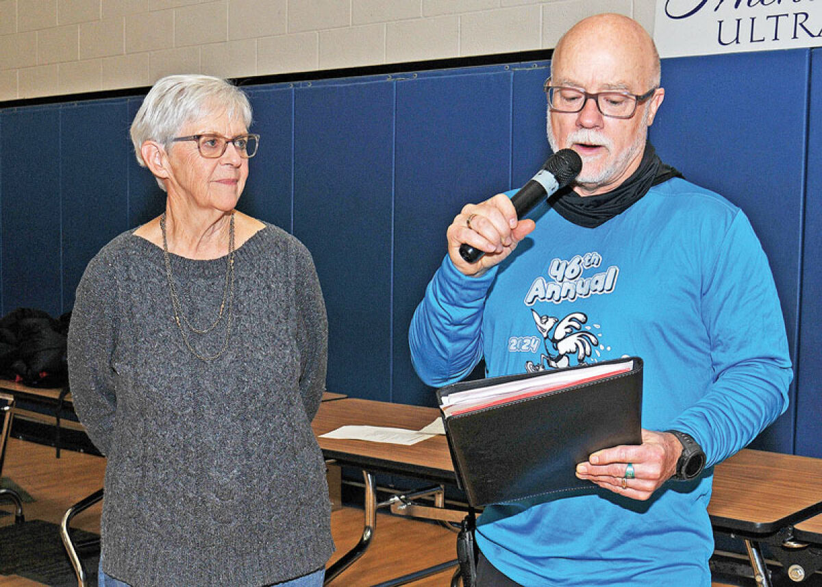  Recreation Authority of Roseville and Eastpointe Director Tony Lipinski, right, held a moment of silence at the Big Bird Run Nov. 9 to honor longtime running participant Darrell McKee, who died this year at the age of 90. Next to him is McKee’s widow, Ellen McKee. 