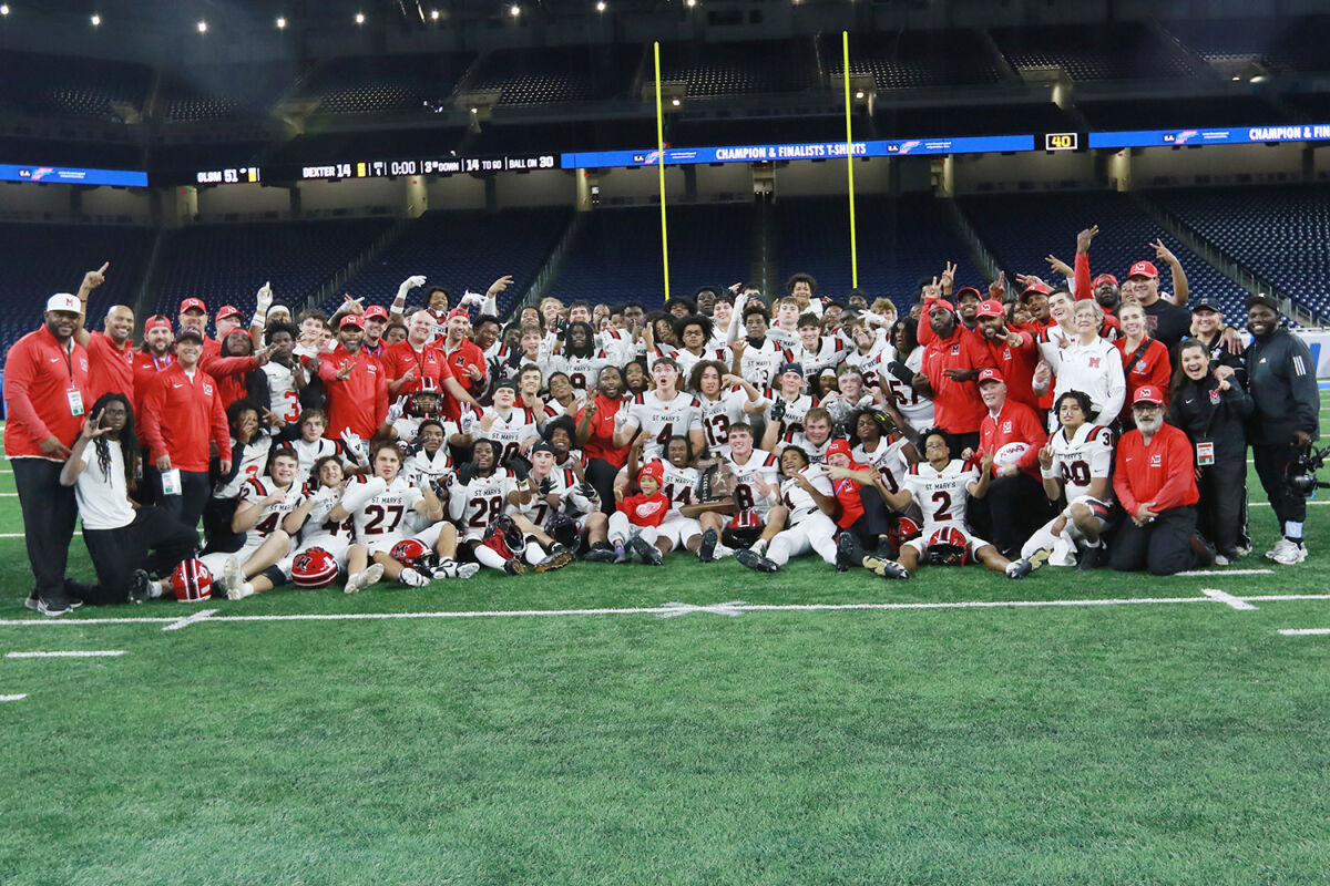  The Orchard Lake St. Mary’s football team celebrates Nov. 28 at Ford Field in Detroit with the MHSAA Division 2 trophy after its 51-14 win over Dexter. 