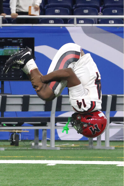  Camari Patterson, of Orchard Lake St. Mary's , does a back flip after winning the state title Nov. 28 at Ford Field in Detroit. 