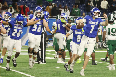  Detroit Catholic Central players celebrate after a 42-19 state championship victory over Detroit Cass Tech on Nov 30 at Ford Field. 