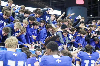  Players celebrate their state title with the Detroit Catholic Central student section at Ford Field. 