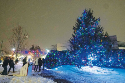  A small crowd of people gather to watch the Eastpointe Christmas tree be lit. 