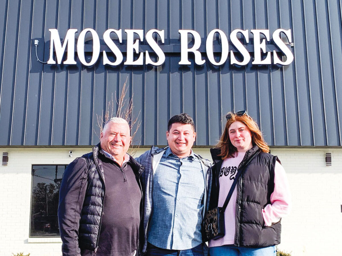  Chris Aiello, corporate attorney, left; Nick Aiello, corporate operating officer; and Jessica Walter, operations manager, pose for a photo outside Moses Roses Monday, Nov. 24, in Eastpointe. 