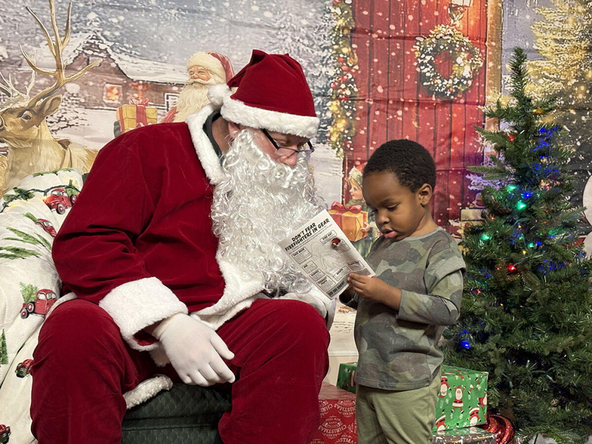  Santana Gibson tells Santa what he would like for Christmas at the Lathrup Village Winter Festival and Tree Lighting on Dec. 5. 