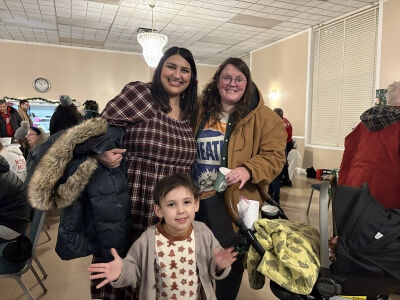  Anissa Lefevre, left, and Bridget Lefevre, right, with their son, Mateo Lefevre, enjoy the Lathrup Village Winter Festival and Tree Lighting on Dec. 5 