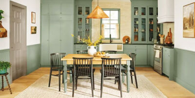  Valspar’s color of the year,  “warm eucalyptus,” is featured on the cabinets  of this inviting kitchen area.  