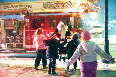 Amid North Pole snow and cold, Santa Claus arrives on a Clawson fire truck.