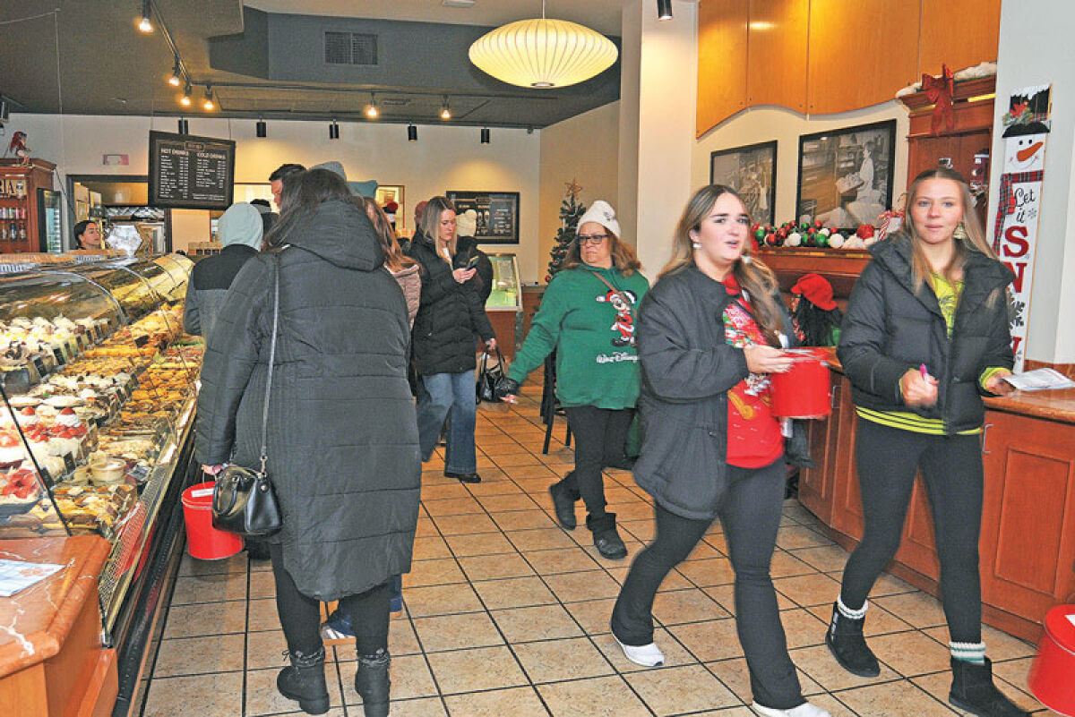  People walk through Astoria Bakery in Royal Oak during the Cookie Crawl on Dec. 6, which was an activity on one of the weekends of Royal Oak Holidays. 