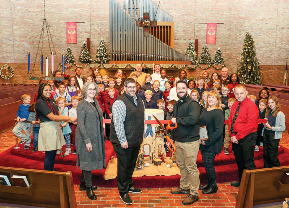  The Royal Oak Chamber of Commerce recognized St. Paul Lutheran Church and School for its 150th anniversary and renovations on Dec. 2. Pictured, Chris Schultz, president of the congregation; Marshall Mackinder, financial secretary of the congregation; and Chris Francik, school principal, help the Rev. Jake Andrzejewski cut the ribbon during a ceremony. 