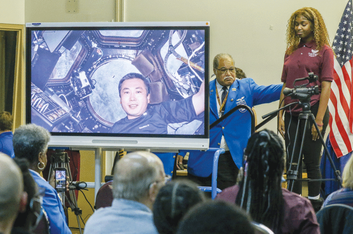  Benjamin O. Davis Aerospace Technical High School 10th grade student Brianna Thompson listens to Japanese astronaut Koichi Wakata, pictured on the computer screen, from space Oct. 18.  