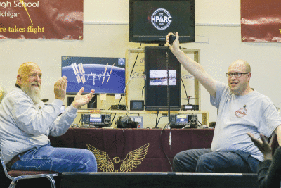  Hazel Park Amateur Radio Club members Michael Slupinski, of Warren, left, and Michael Phipps, of Hazel Park, right, connect with Japanese astronaut Koichi Wakata.  