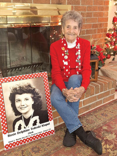  Delphine Tedeski Klaput sits next to a photo of herself as a young woman, when she served as a Rosie the Riveter. 
