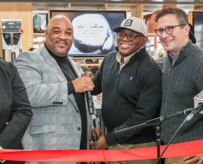  Johnny Cannon, left, and Joe Louis Barrow Jr., right, cut the ribbon at the grand opening for the Southfield location of Joe Louis Southern Kitchen on Dec. 9. 