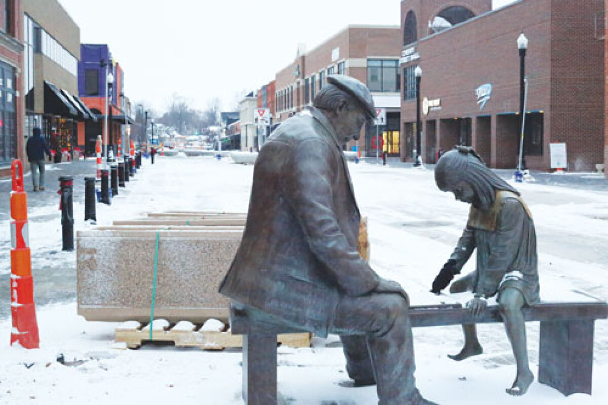 Janice Trimpe’s sculpture “Apple of my Eye” has returned to Macomb Place, located outside of Black Cat Coffee on the afternoon of Dec. 9. Movable barriers are stored behind it, still packed on pallets. 