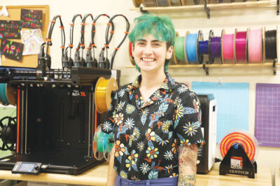  Rae Stoloff, a librarian at the Madison Heights Public Library, tends to equipment in the library’s creative tech space. Stoloff recently received the 2025 Rising Star Award from the Michigan Library Association.  