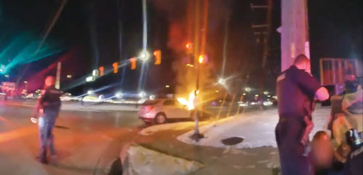  Body cam footage released by the Sterling Heights Police Department shows officers and bystanders working together to rescue a woman from a burning car after a crash Dec. 8. 