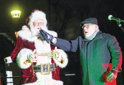  Utica Mayor Gus Calandrino gives the key to the city to Santa Claus at the Downtown Utica Christmas Tree Lighting Celebration in Memorial Park Dec. 13.  