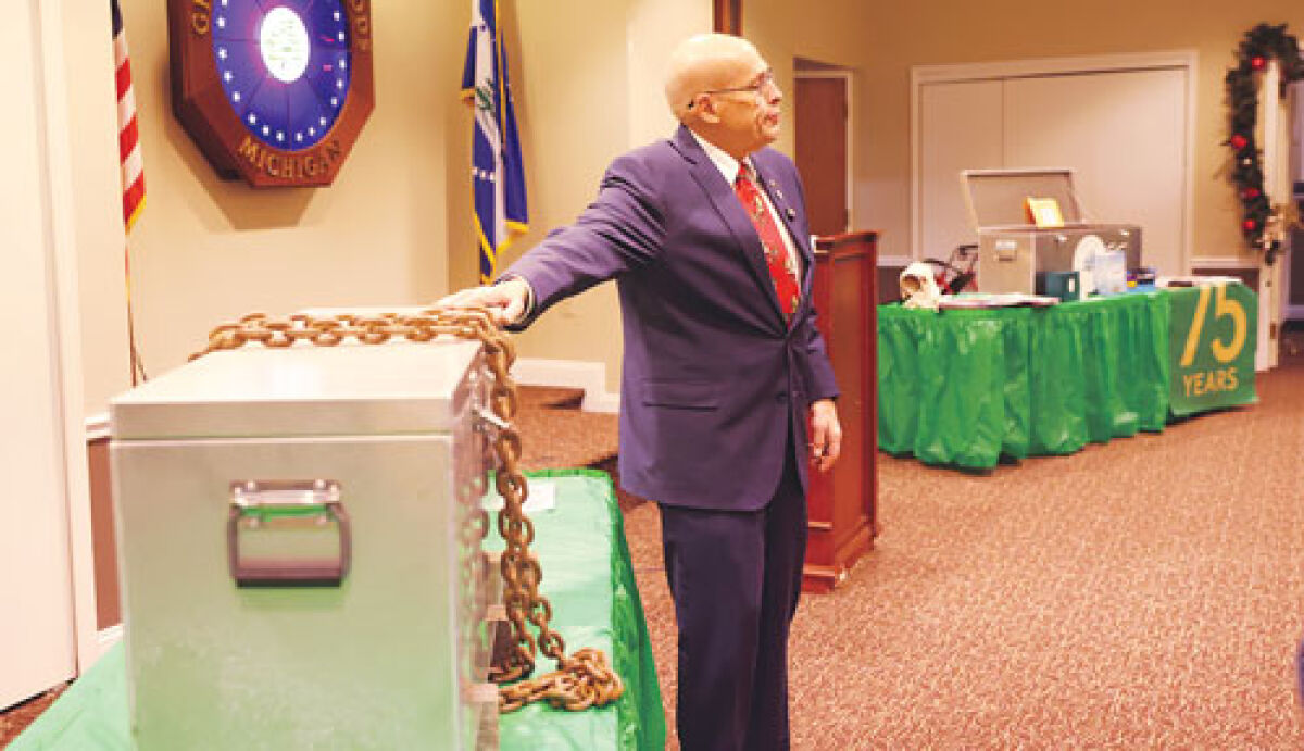  Grosse Pointe Woods Mayor Arthur Bryant talks about the 50th anniversary time capsule before opening it for attendees at a Dec. 11 celebration for the city’s 75th anniversary at the Community Center.  
