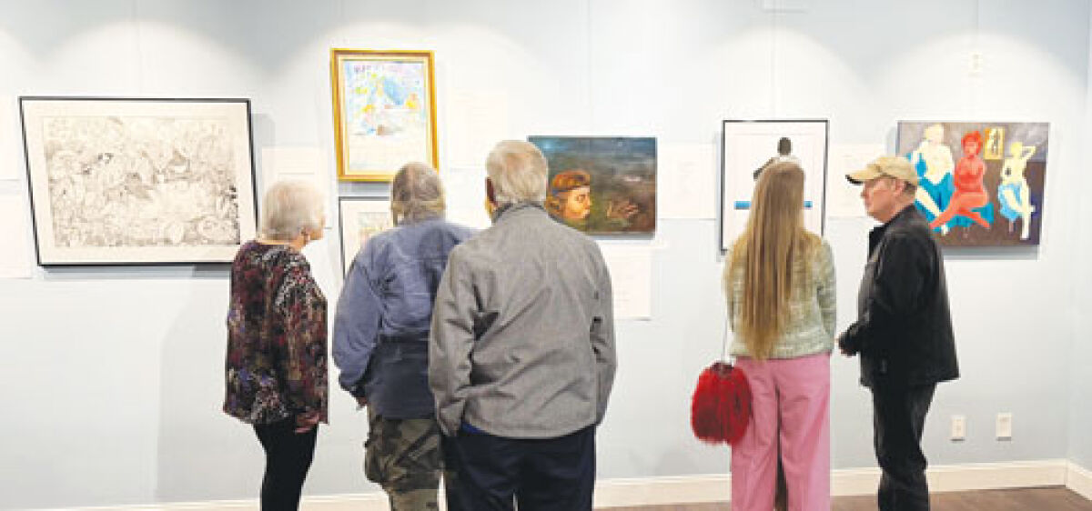  Visitors view the artwork and read the poems on display for “Call & Response 5” during an opening reception Nov. 6. 