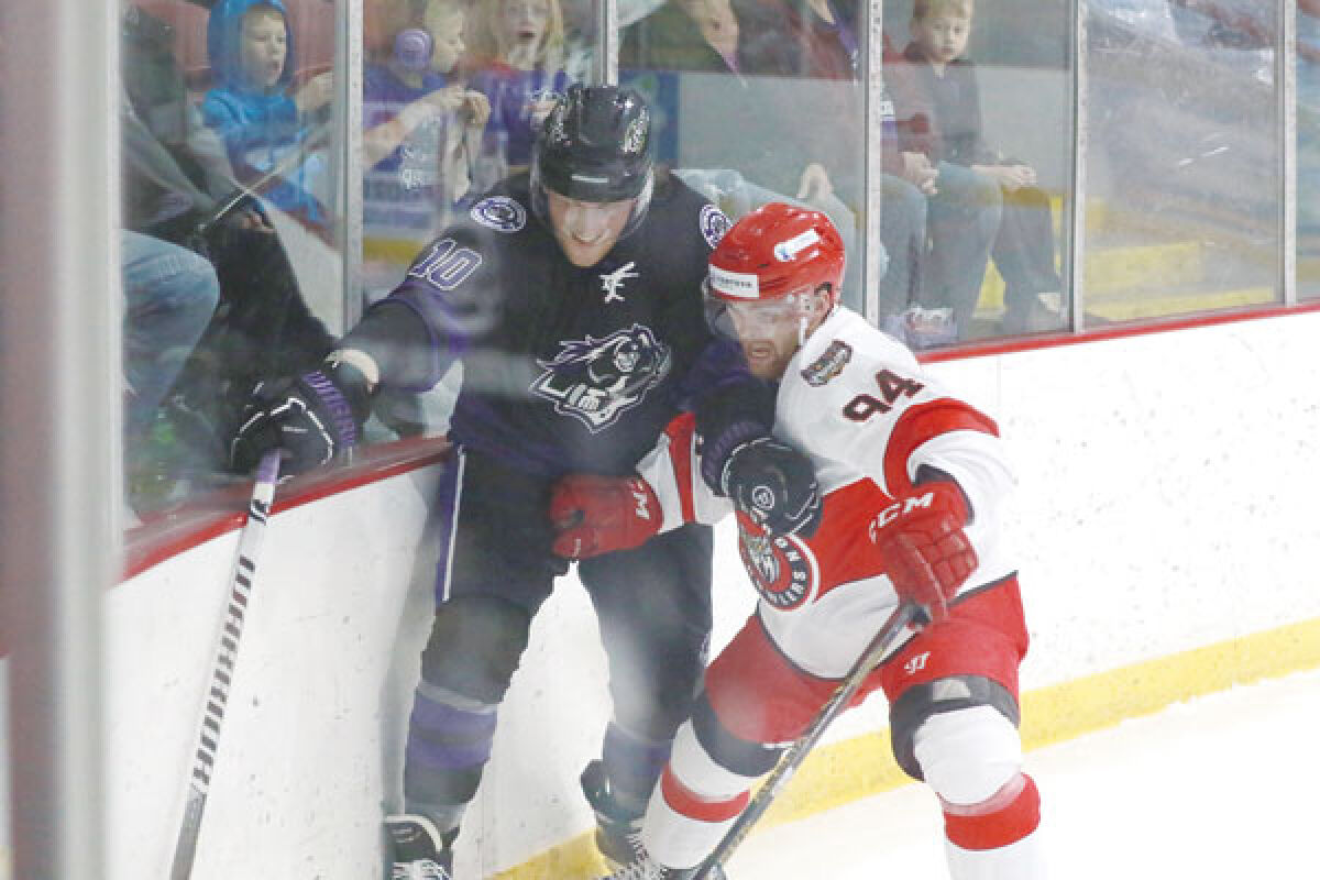  Roman Gaudet of the Motor City Rockers fends off Evan Foley of the Port Huron Prowlers near the boards in the Rockers’ opening game on Oct. 13  at Big Boy Arena.  