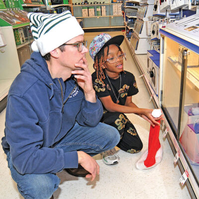  Southfield firefighter Chris Siewert and Akai Hayes, 8, look over some Nintendo electronics. 
