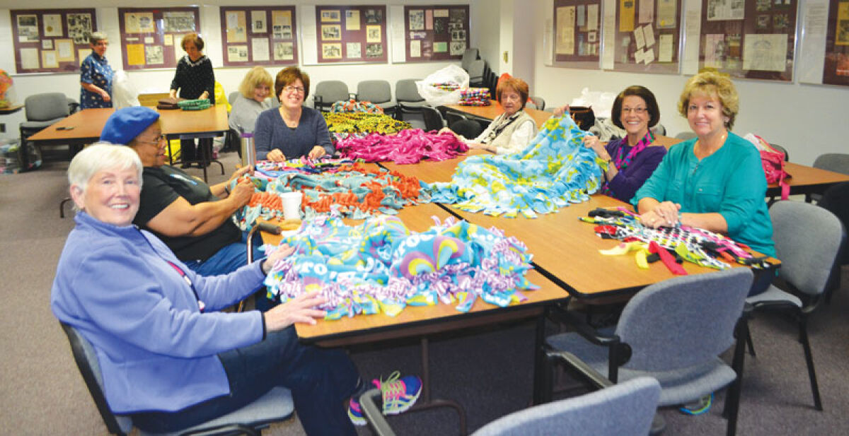  Volunteers for Wrapped in Love tie fleece blankets. 