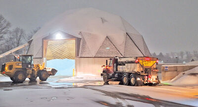 Workers fill trucks using salt housed inside this salt dome at the Novi Department of Public Works. 