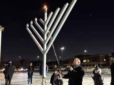  Southfield City Clerk Gabi Grossbard lights the menorah in the Southfield Public Library parking lot on Dec. 16. 