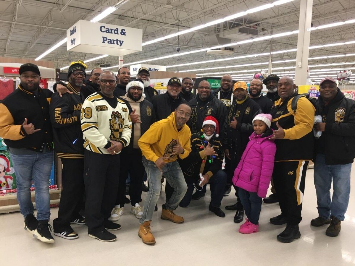  Southfield Alphas gather with families in the card and party aisle at Meijer during the 2023 How the Alphas Gave Christmas event. 
