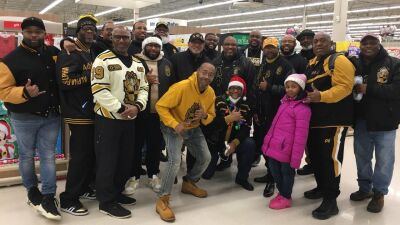  Southfield Alphas gather with families in the card and party aisle at Meijer during the 2023 How the Alphas Gave Christmas event. 