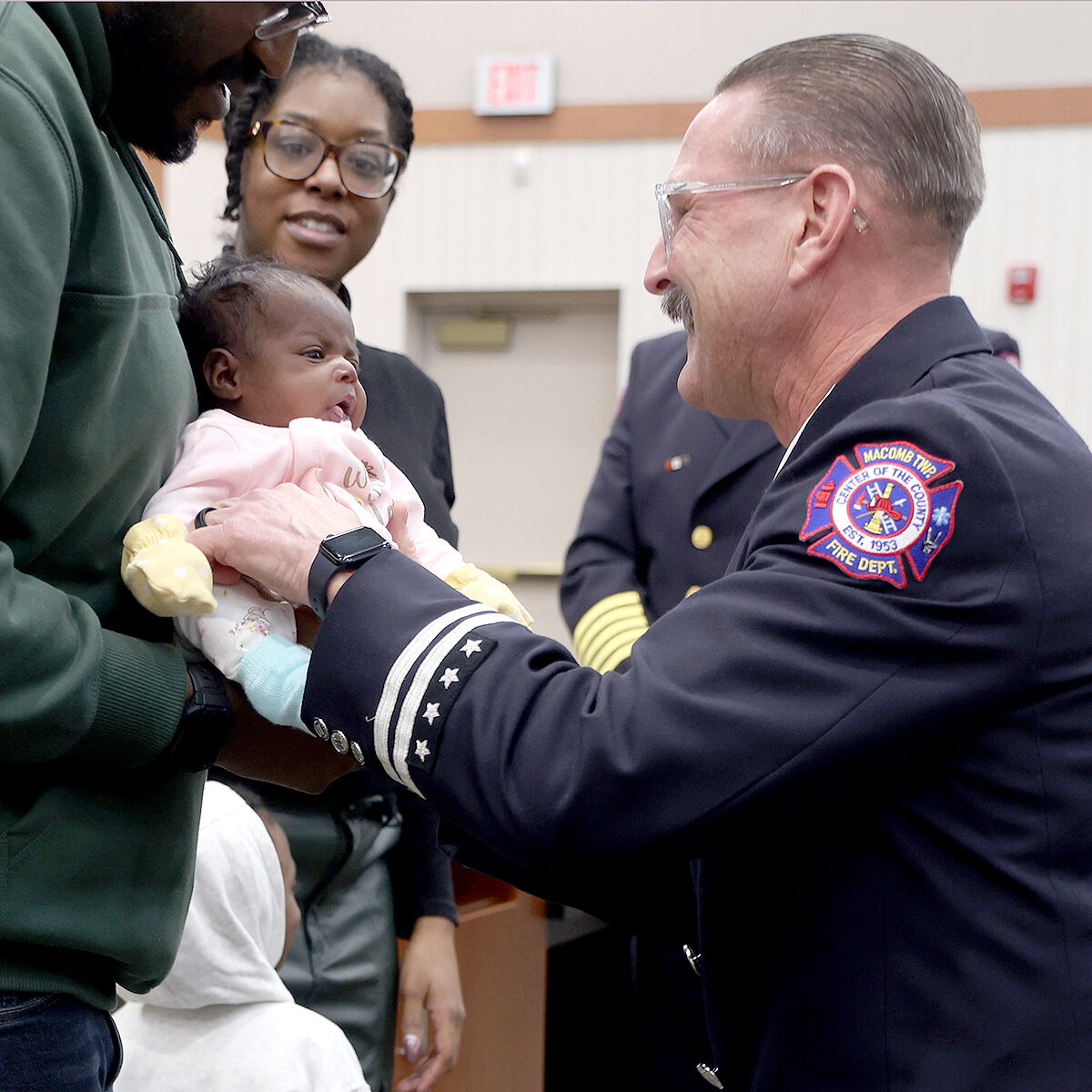  Parents Stephan Smith and Leeshauna Brown joined Macomb Township Fire Department Capt. Ken Bartz, who holds 1-month-old Amarla Brown for the first time after helping deliver her at home. 