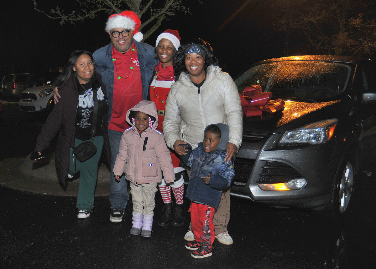  LaToya Singley, right, stands in front of her new car with her children, Donelle, 3, Cherish, 4, and Jer-laya, 12, left. Joining them are Mark and Shawanna Watts. 