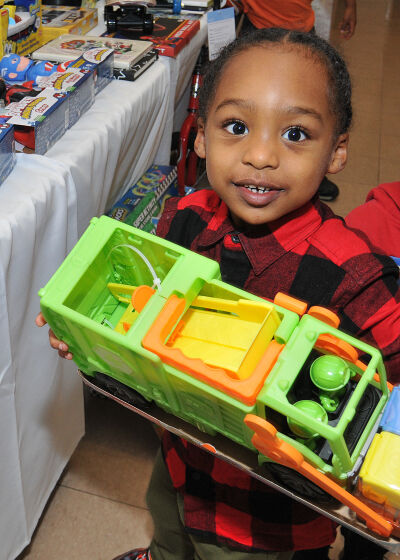 Four-year-old Dom Yelder picks out a colorful garbage truck toy to take home at a toy drive at Lathrup Village City Hall hosted by Boys 2 Men Youth Mentoring and the Lathrup Village Chamber of Commerce on Dec. 18. 