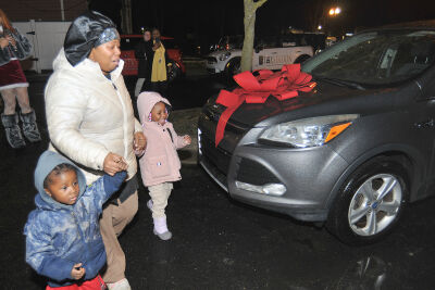 LaToya Singley walks to her new car with her children Donelle, 3, and Cherish, 4, on Dec. 18.