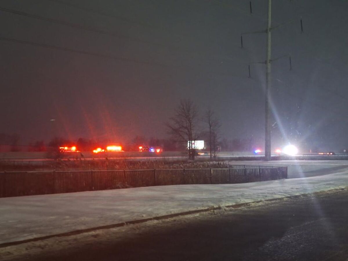  Many emergency lights can be seen along eastbound Interstate 96 during the evening Jan. 1 as police respond to a seven-vehicle crash. 