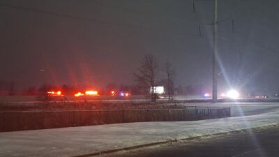  Many emergency lights can be seen along eastbound Interstate 96 during the evening Jan. 1 as police respond to a seven-vehicle crash. 