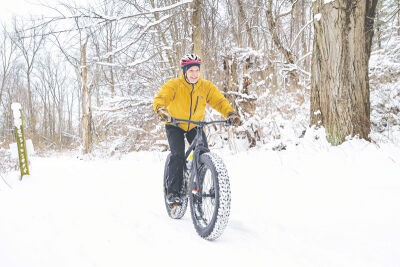  A fat-tire bicyclist enjoys the trails at Independence Oaks County Park. 