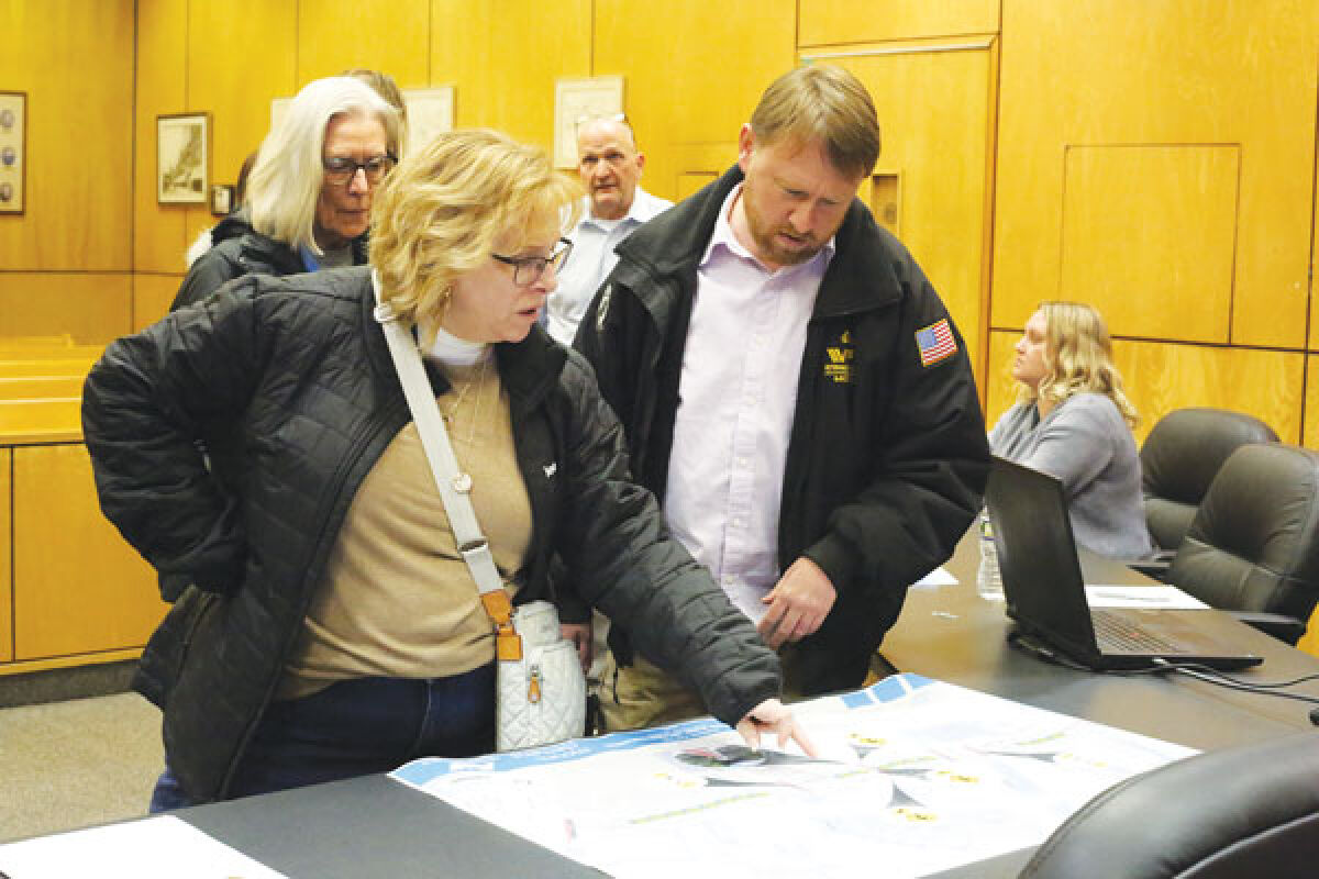  Public Hearing attendee Nancy Stadler and Mount Clemens City Commissioner Erik Rick look over the North Main Street road diet’s proposed pedestrian safety measures before a public hearing on Jan. 7. 