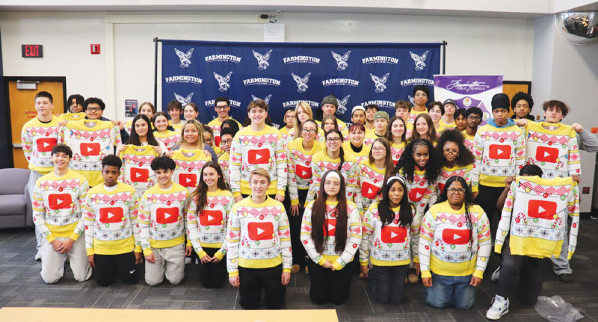  Carter O’Driscoll, in the middle of the second row, and his marketing classmates at Farmington High School  show off the “ugly sweater” he designed with the YouTube logo. YouTube used the design to celebrate its  anniversary and compensated O’Driscoll with a $10,000 licensing deal. 