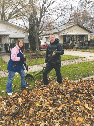  In this file photo from 2018, Brian Hartwell — then the mayor of Madison Heights, now the judge of the 43rd District Court in Hazel Park — and Roslyn Grafstein — then a Madison Heights City Council member and now the mayor of Madison Heights — rake leaves for residents as part of the “Rake with the Mayor” program. Grafstein is continuing the tradition this year. 
