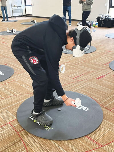  Roseville High School 10th grade student Cash Defour tries out the crime scene investigator and plumber roles during a virtual reality simulation program held Dec. 12. 