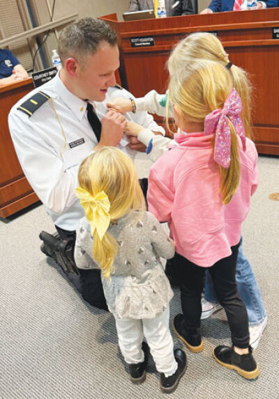  Grosse Pointe Shores Public Safety Lt. Ryan Wilson’s new badge is pinned to his uniform by his young daughters. 