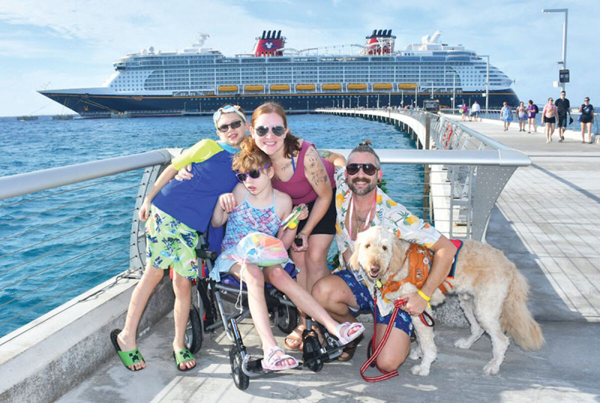  The Terpstra family poses for a picture with the Disney cruise ship. 